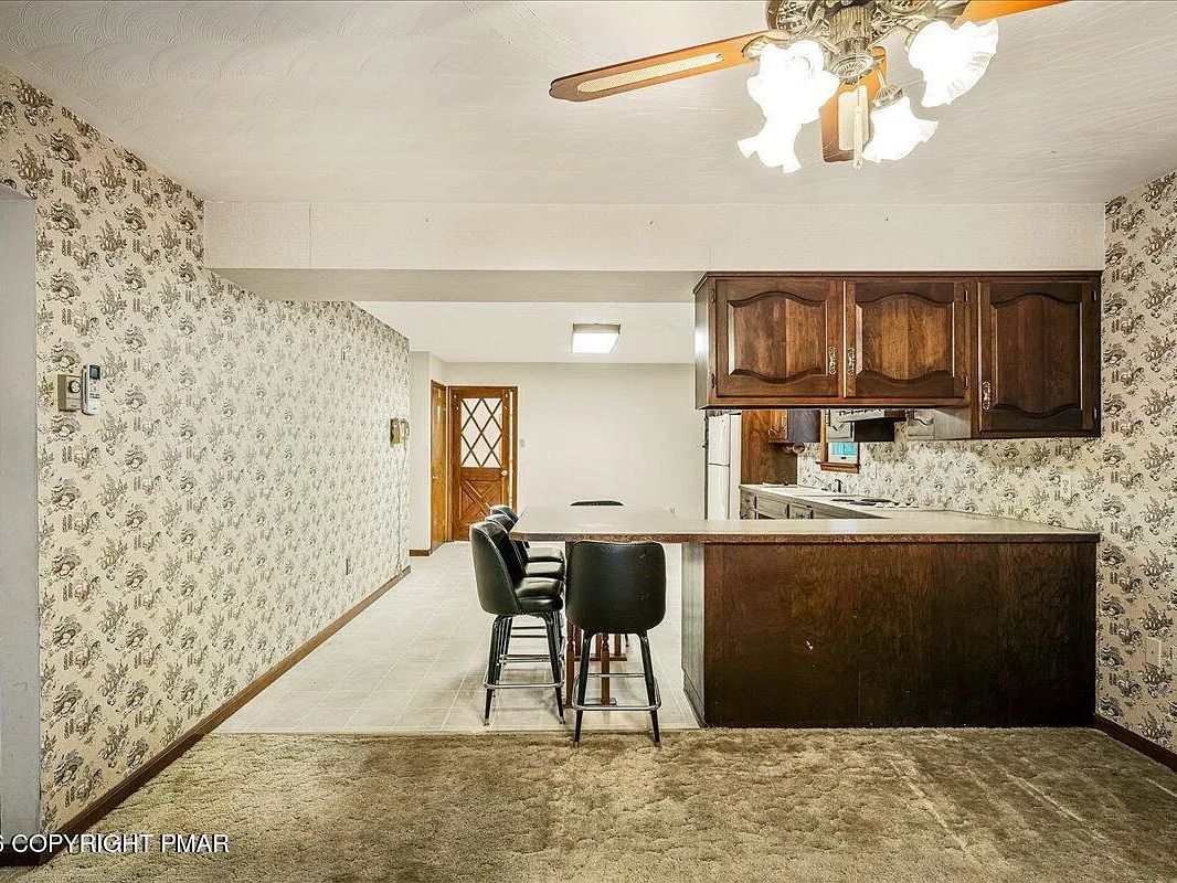 Two-storey home on Baines Lane in Dallas, PA with attached garage on a wooded lot