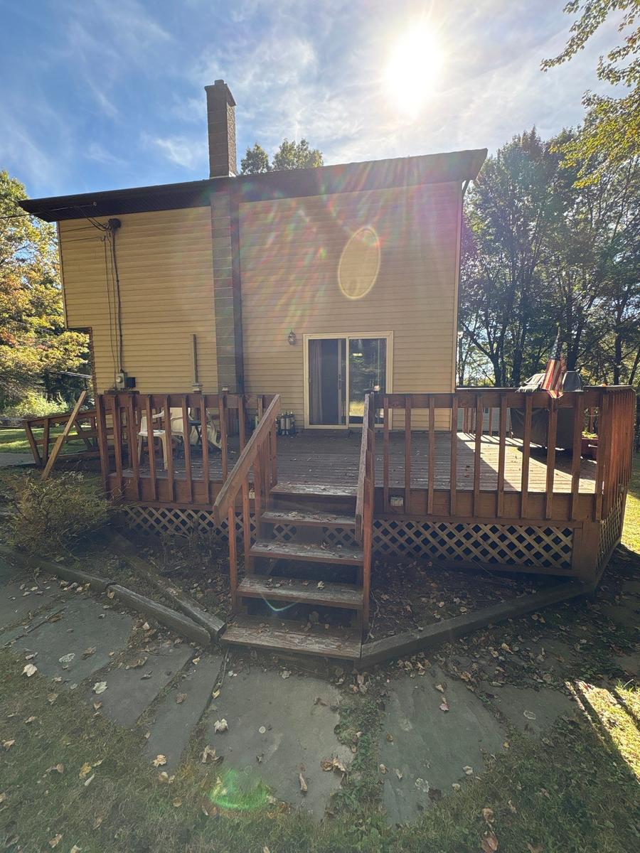 Dallas PA rear deck and exterior before — aging wood deck, wooded lot