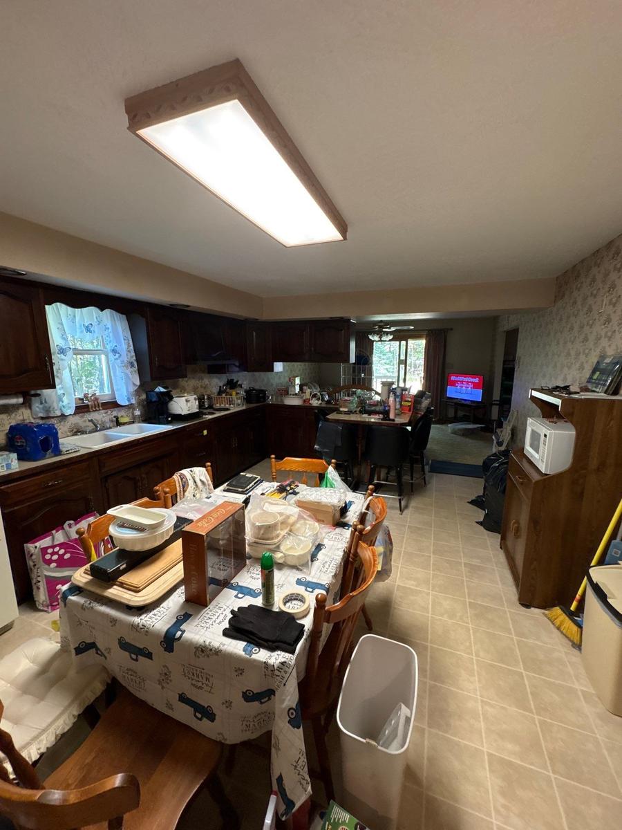 Dallas PA home kitchen before — dark walnut cabinets, dated finishes, cluttered