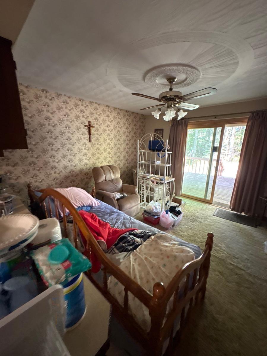 Dallas PA living room before — floral wallpaper, dated carpet, original condition
