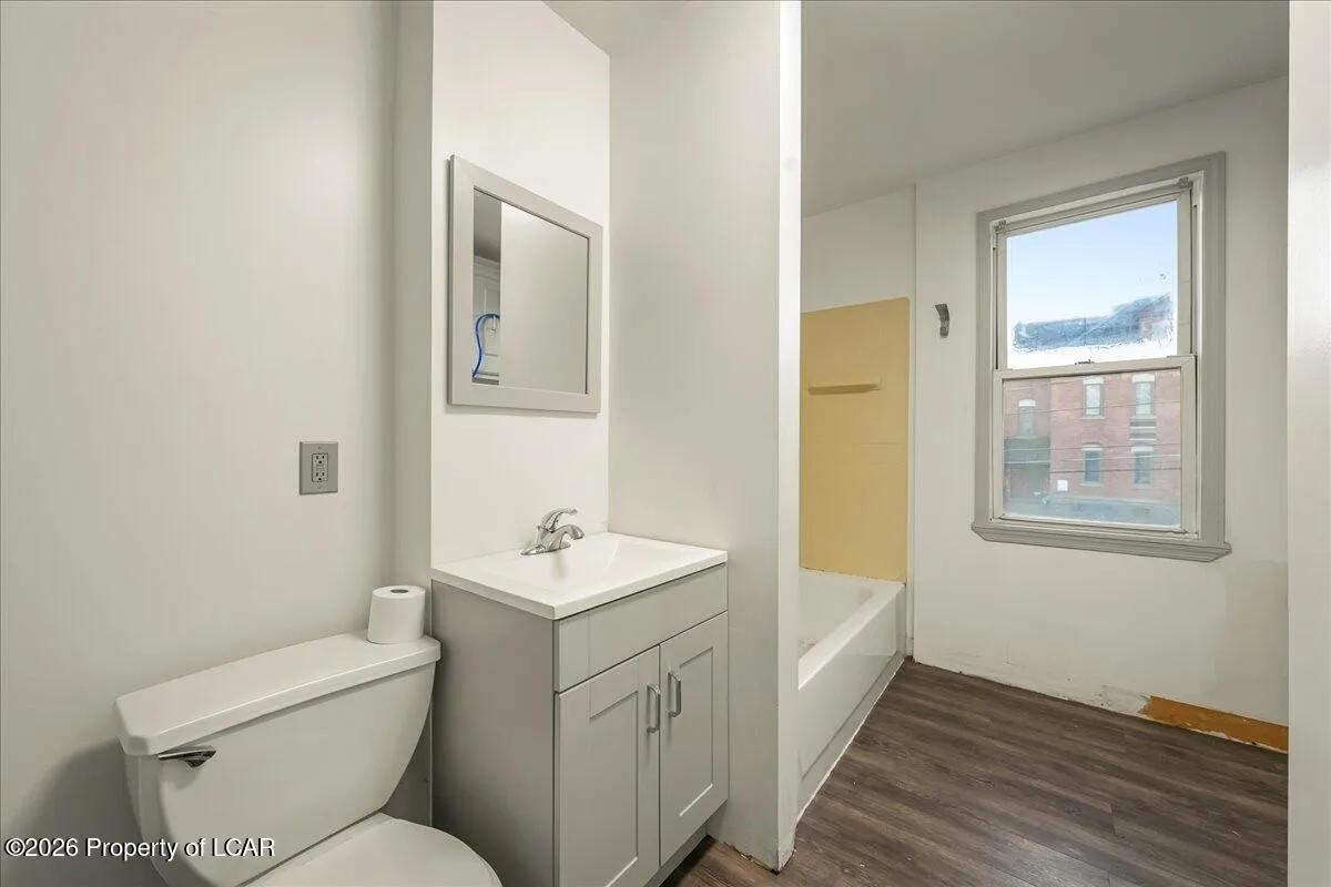 Wilkes-Barre unit bathroom after — new vanity, toilet, and LVP flooring installed