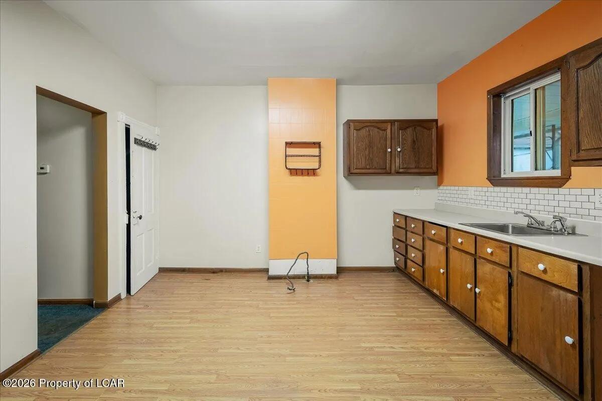 Wilkes-Barre unit kitchen after — cleared, original cabinets retained, LVP flooring