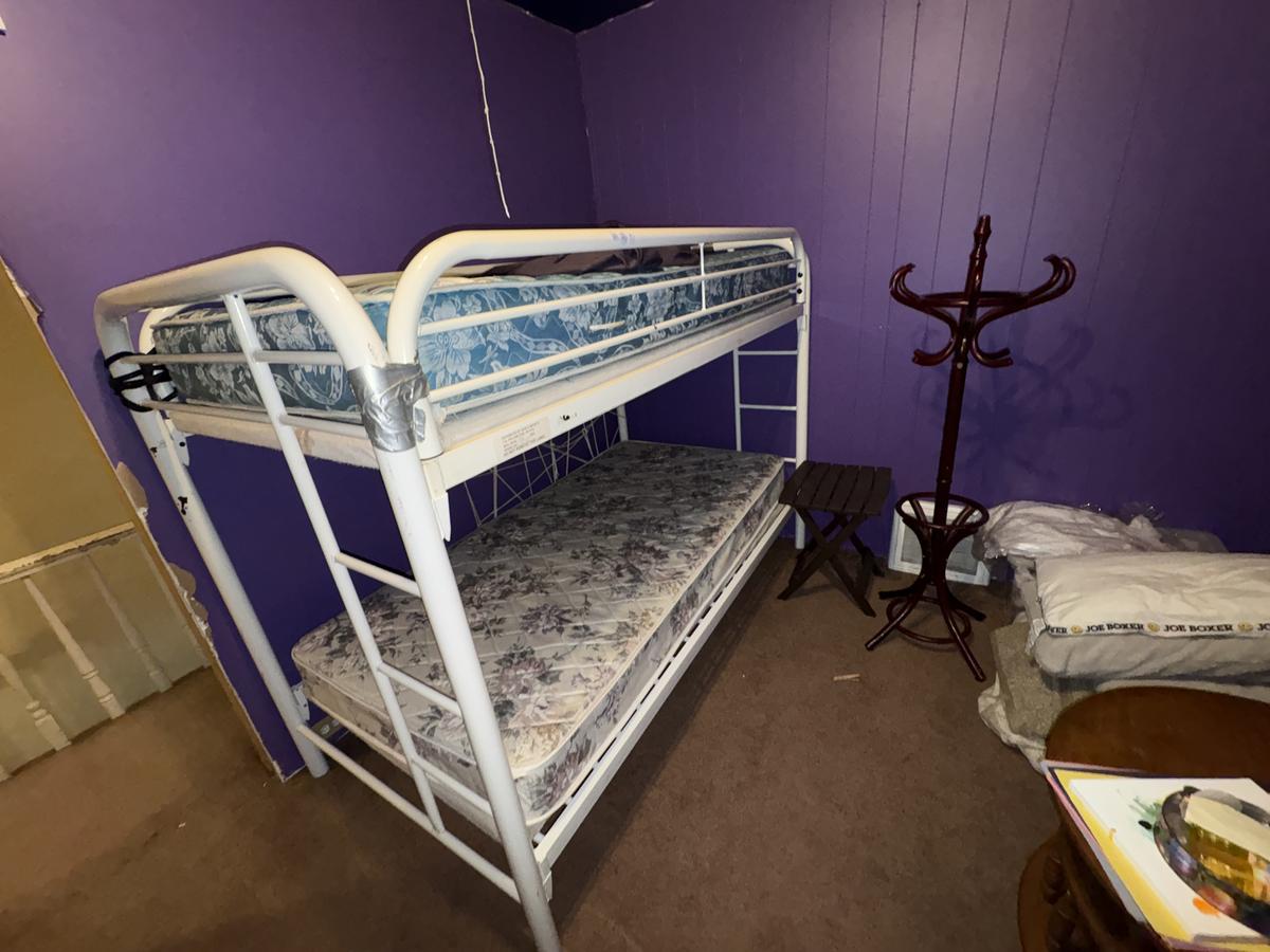 Wilkes-Barre unit bedroom before — purple walls, bunk beds, occupied condition