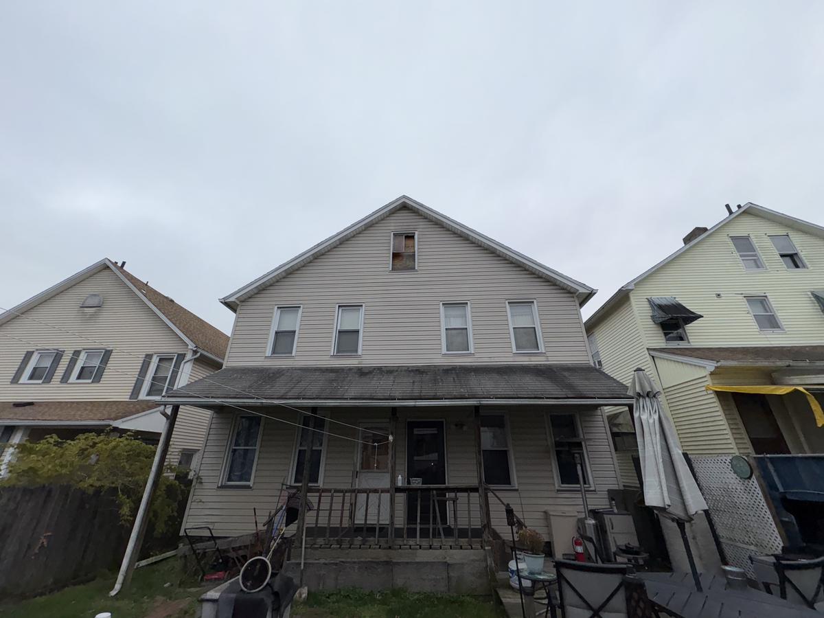 Wilkes-Barre double before — two-unit vinyl siding exterior, covered porch