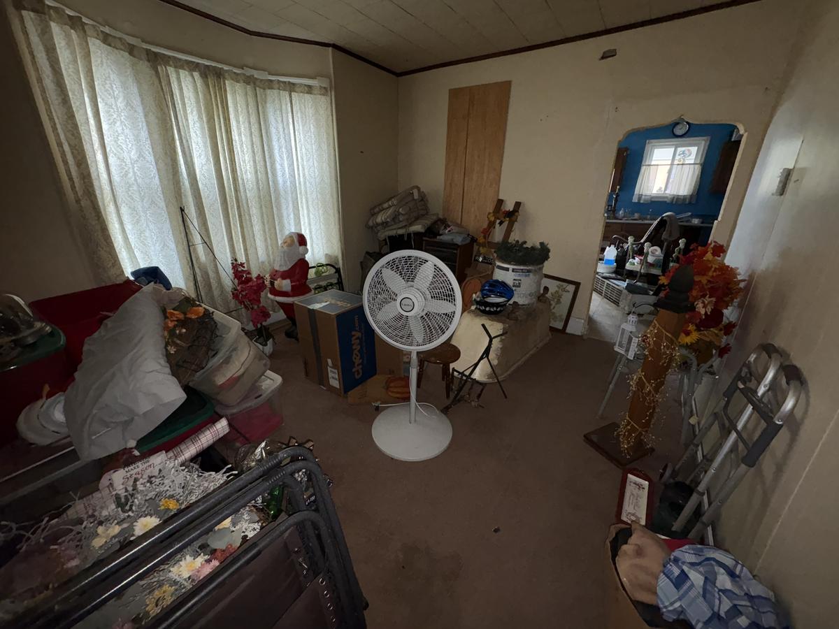 Wilkes-Barre unit living room before — cluttered with personal belongings