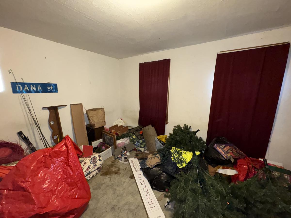 Wilkes-Barre unit room before — cluttered, red curtains, abandoned belongings