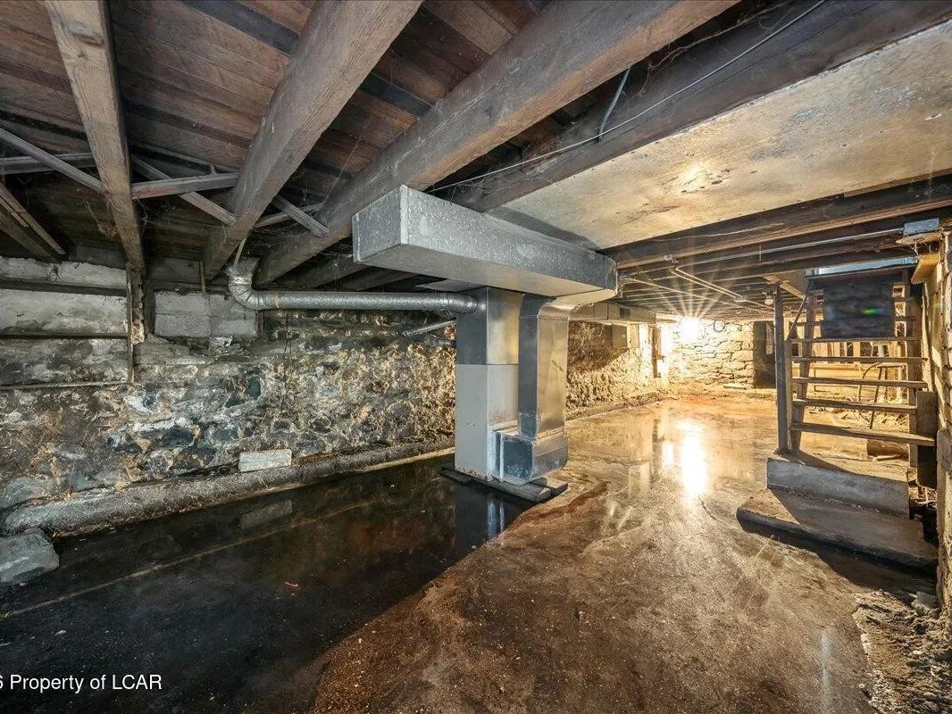 Standing water across the basement floor of the Wilkes-Barre, PA property found at final inspection