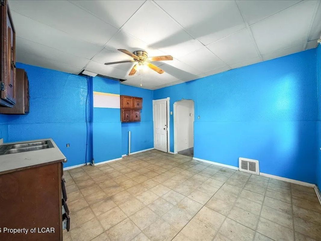 First-unit kitchen with painted walls and dated cabinetry in Wilkes-Barre, PA