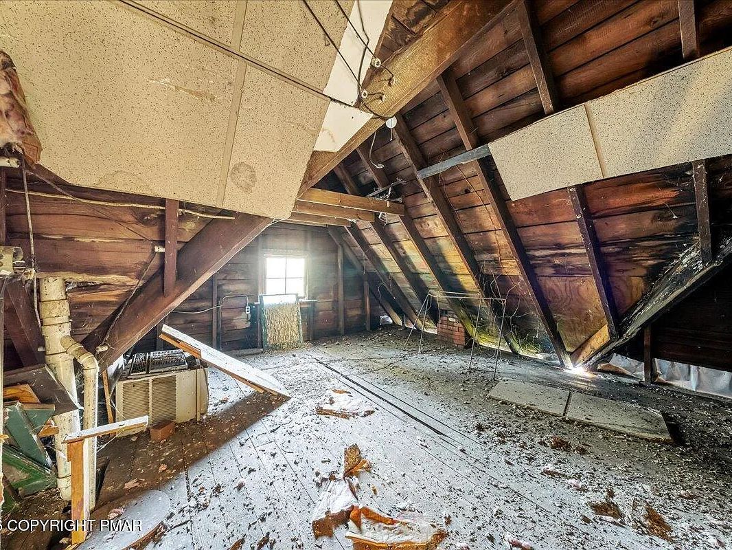 Attic level showing structural damage and debris in the Williamsport Victorian