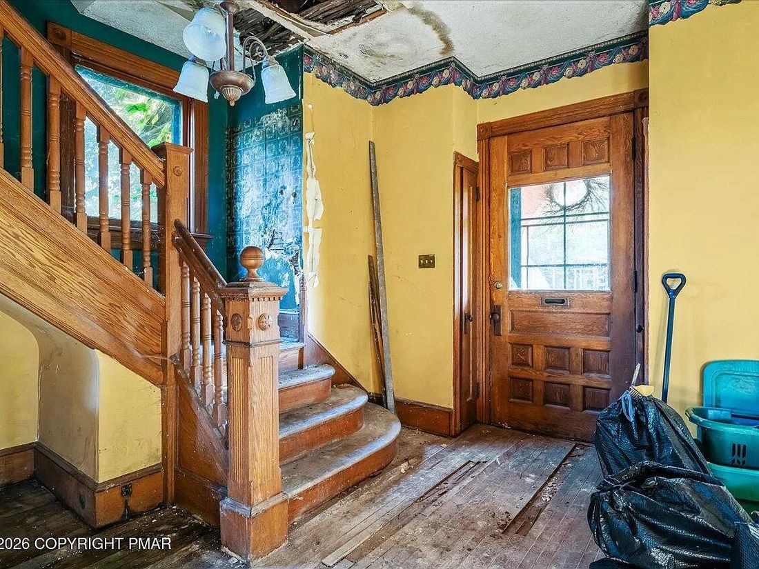 Original carved staircase and newel post in the 1901 Williamsport Victorian