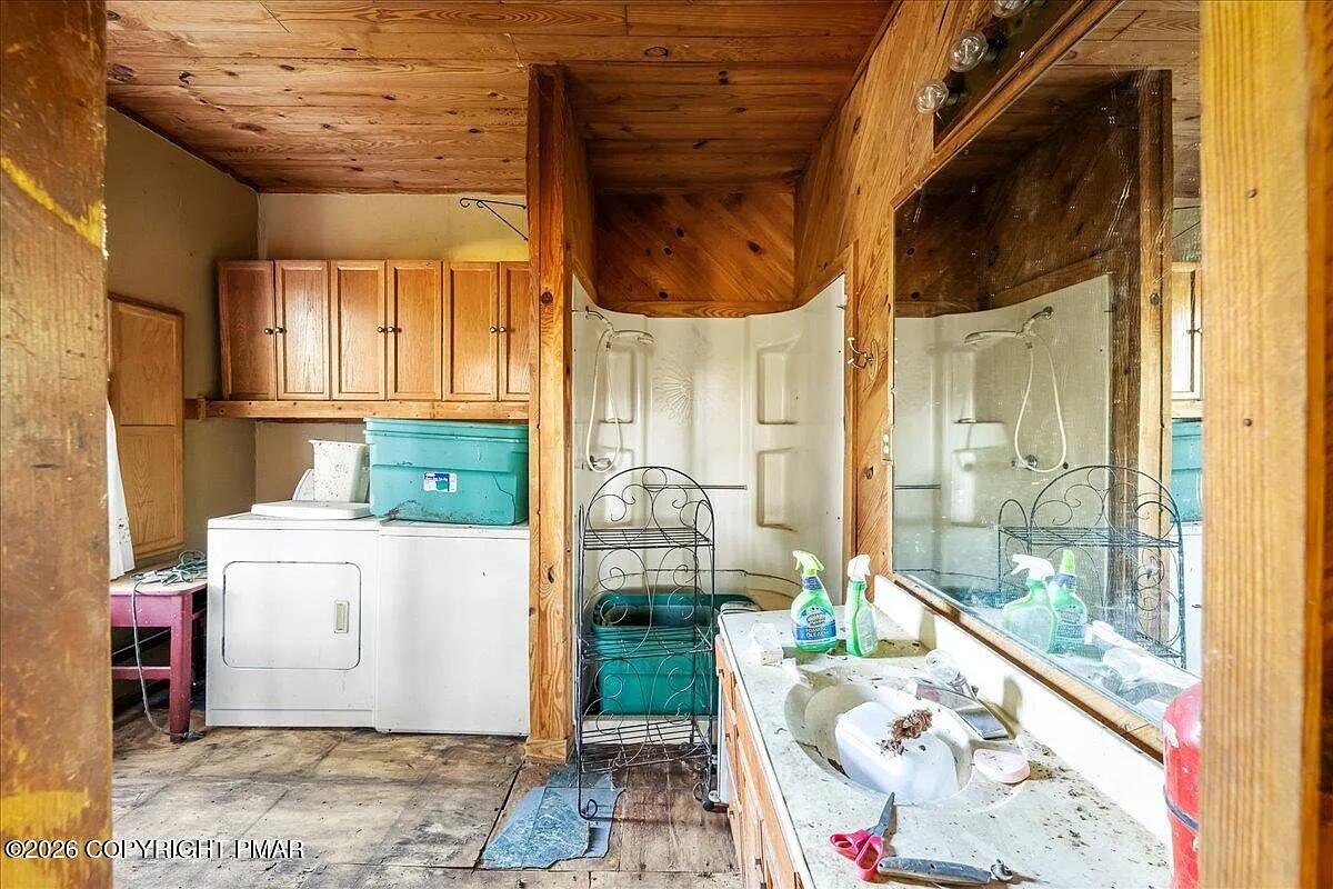 Victorian bathroom after — pine ceiling, original fixtures, laundry alcove